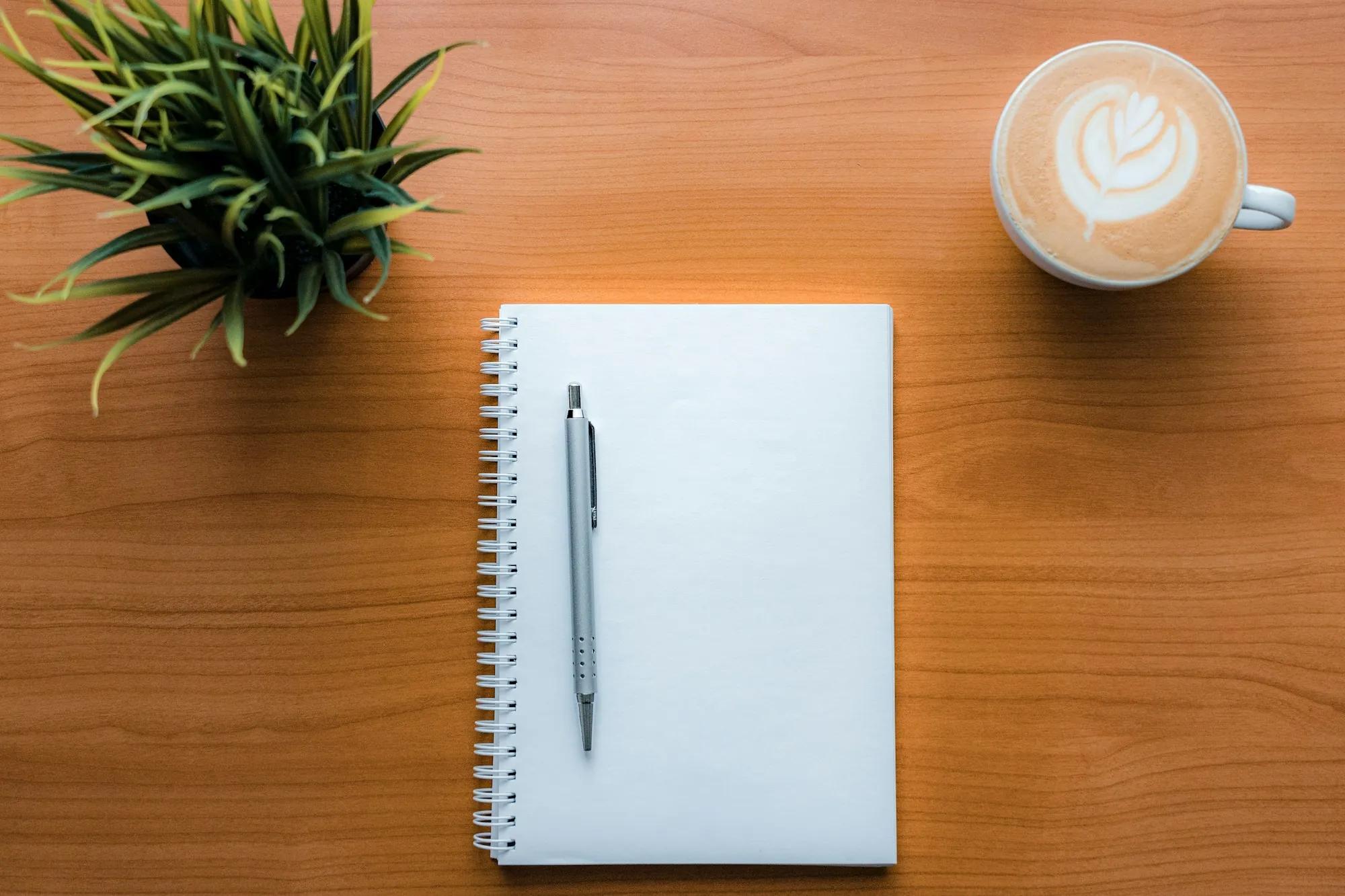 Water Quality Tips & Guides for Fountain Valley Homeowners Notebook, pen and a cup of coffee on a wooden desk
