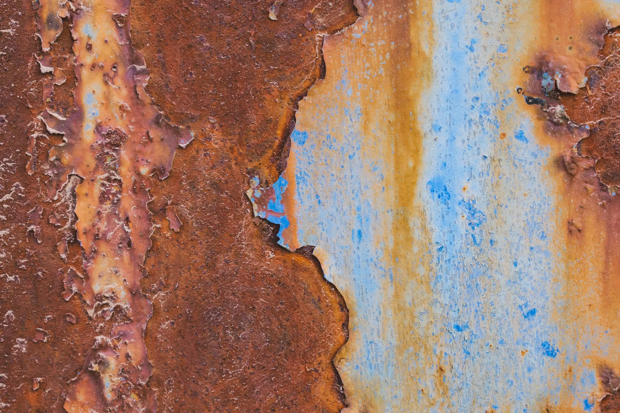 Orange rust stains on a painted metal surface
