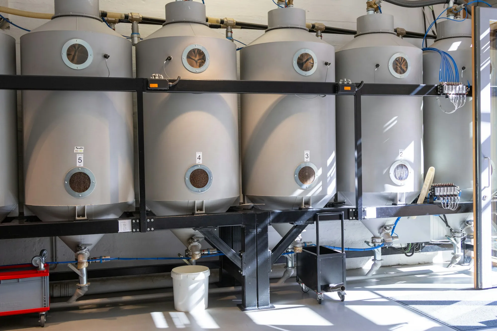 Row of stainless steel tanks in a commercial facility
