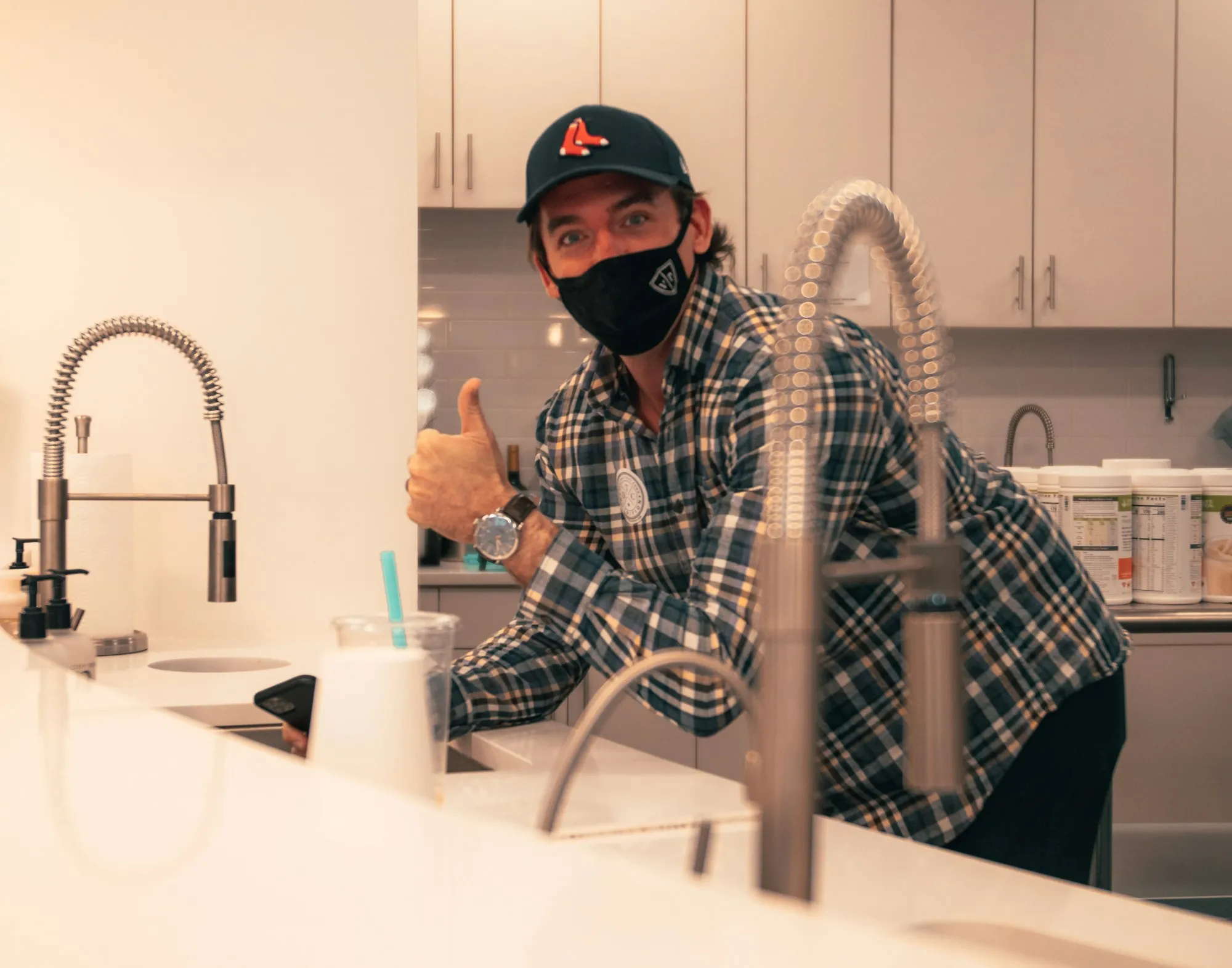 A Local Team That Knows Fountain Valley Water Technician giving a thumbs-up next to a kitchen faucet